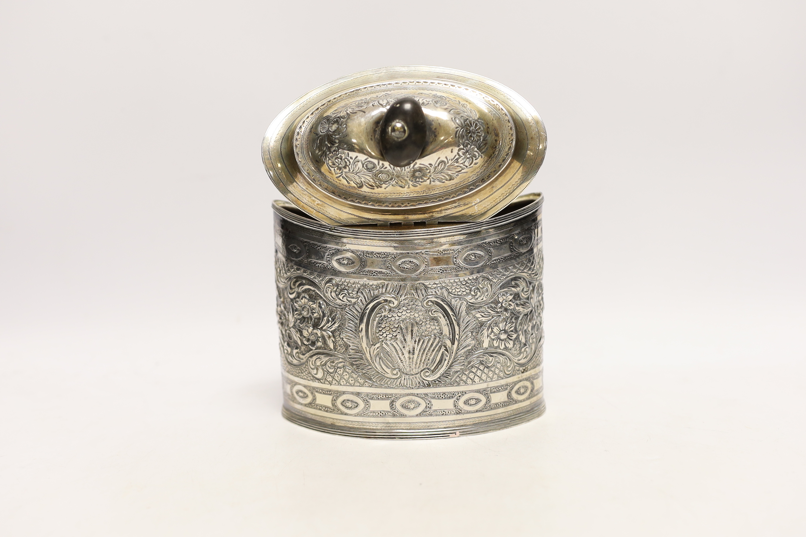 A George III silver oval tea caddy, with later embossed decoration, Peter & Ann Bateman, London, 1796, height 15.2cm, gross weight 11.2oz.